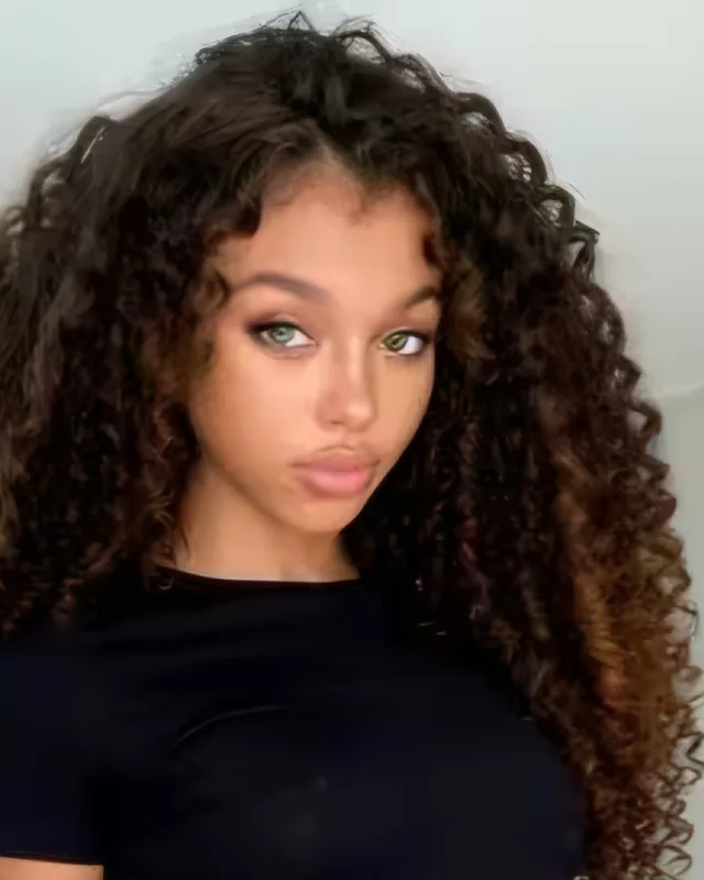 Adult AI-generated woman with curly hair in a dark top